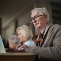 An older man staring at his computer
