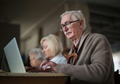 An older man staring at his computer