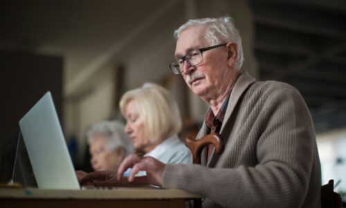 An older man staring at his computer