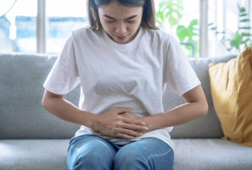 A woman holding her belly in pain