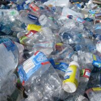 a wasteland of used, crushed plastic bottles