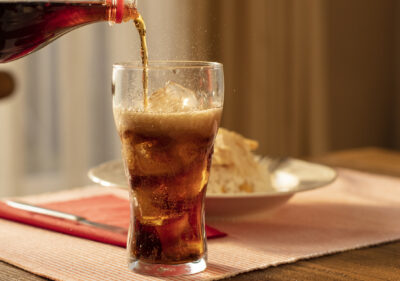 Someone pouring a glass of Diet Coke