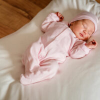 A baby in a pink onesie