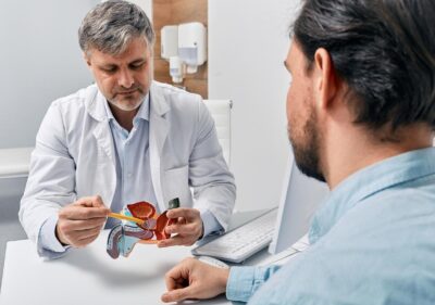 A doctor showing a graphic of a prostate to a patient