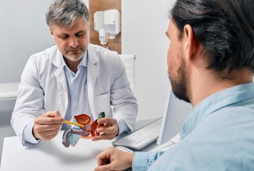A doctor showing a graphic of a prostate to a patient