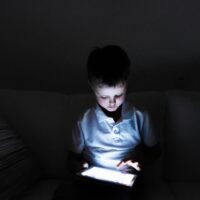 A child looking at a tablet
