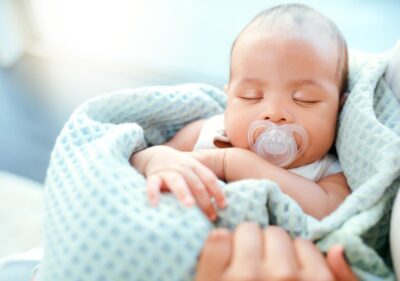 A baby sucking on a pacifier