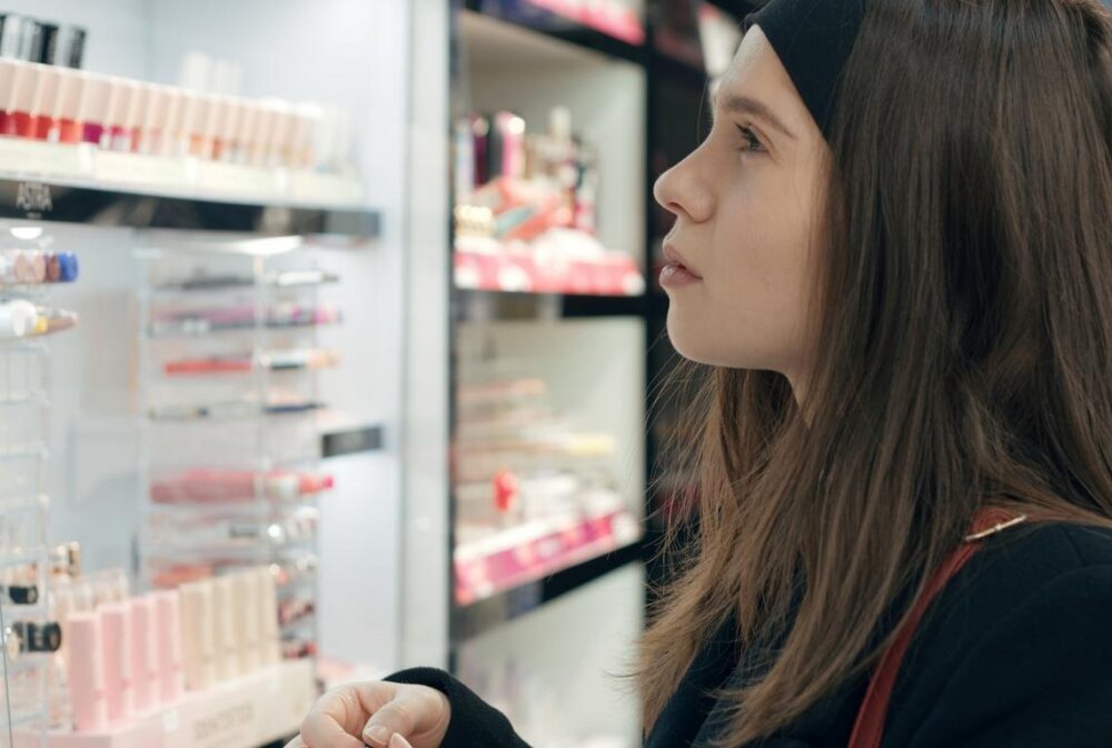 A woman looking at a display of personal care products