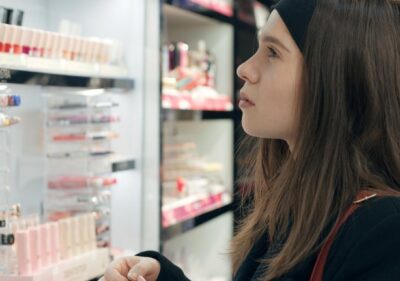A woman looking at a display of personal care products