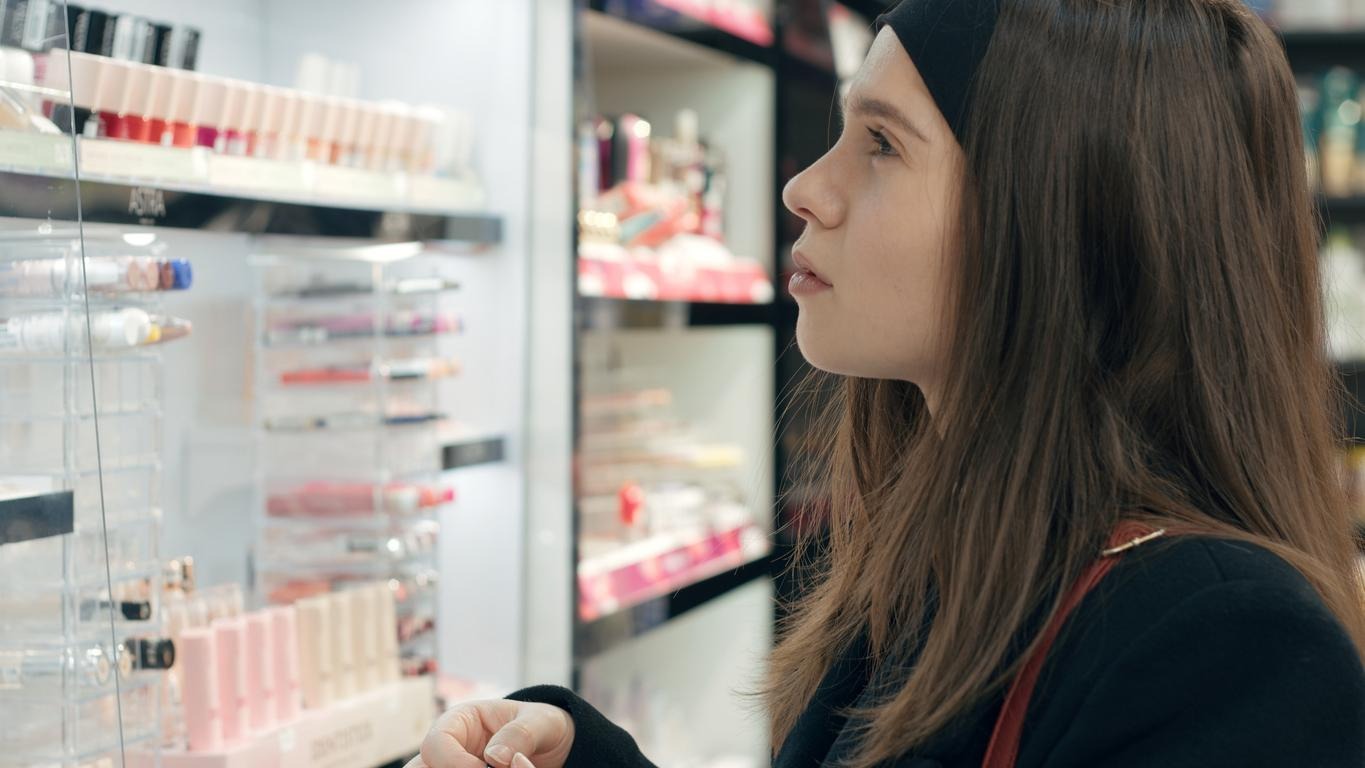 A woman looking at a display of personal care products