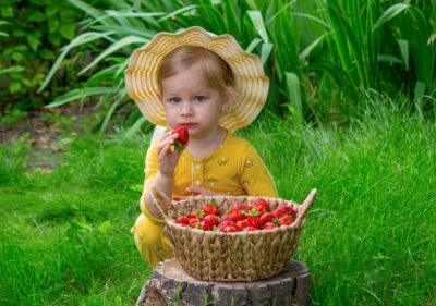 A child with a basket of strawberries