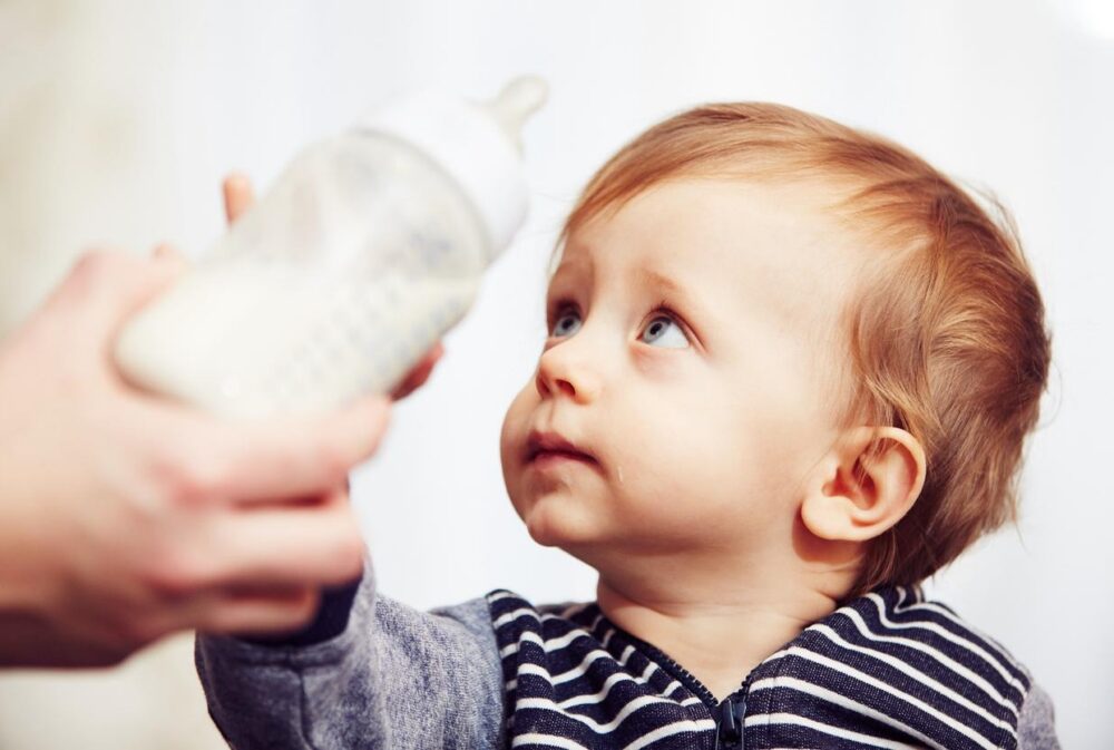 Baby with a plastic bottle