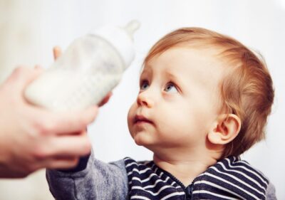 Baby with a plastic bottle