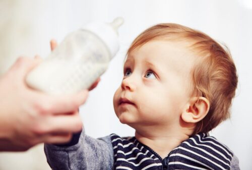 Baby with a plastic bottle
